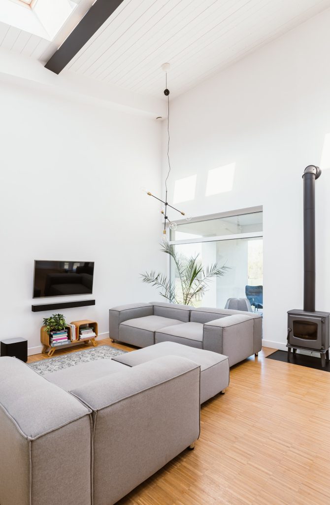 vertical-view-of-elegant-living-room-interior-with-grey-sofa-tv-and-retro-fireplace.jpg